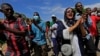 Sudanese protesters march in a demonstration to mark the anniversary of a transitional power-sharing deal with demands for quicker political reforms in Khartoum, Sudan, Aug. 17, 2020.