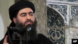 FILE - This image taken from a militant website July 5, 2014, purports to show the leader of the Islamic State group, Abu Bakr al-Baghdadi.
