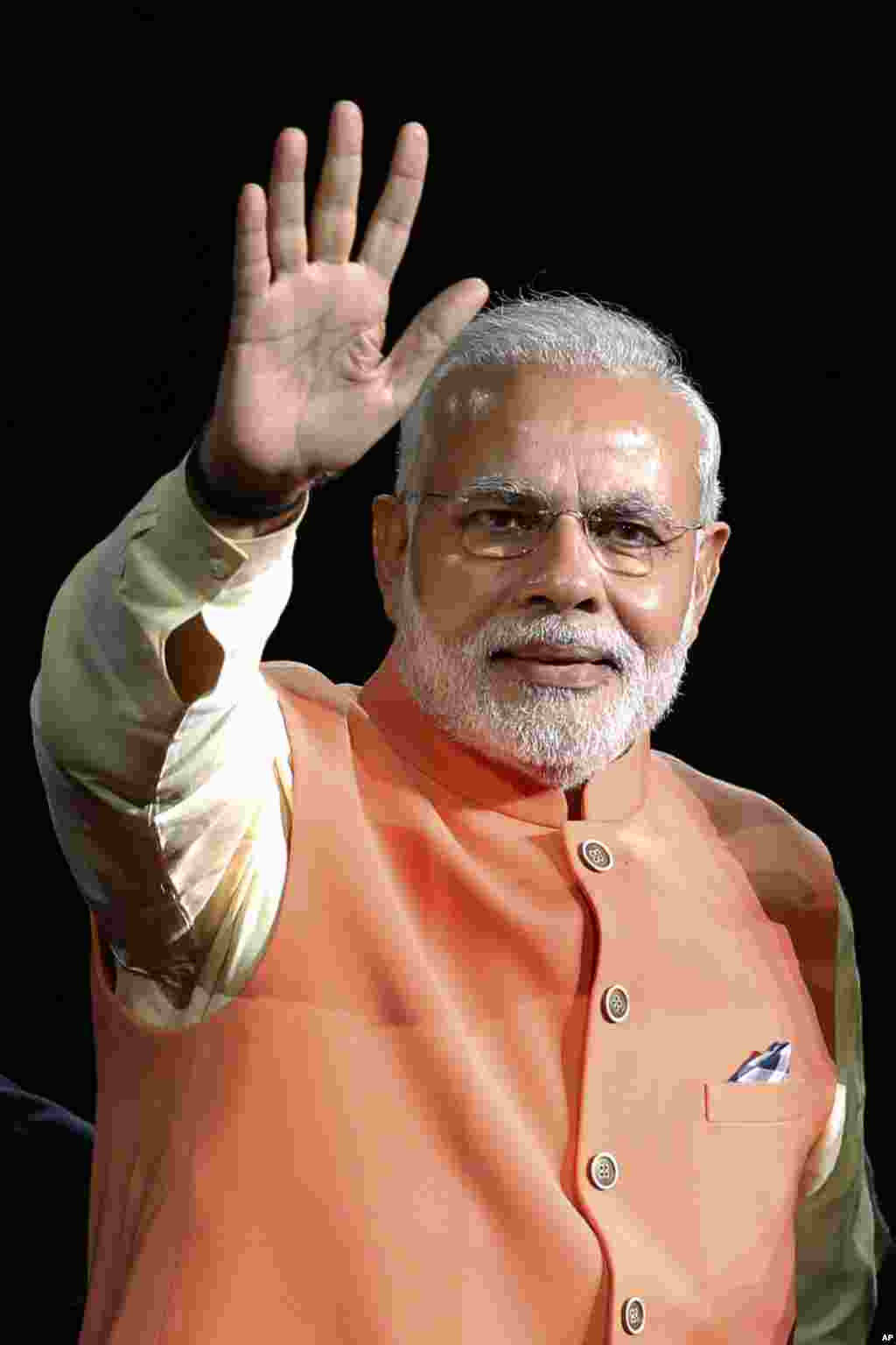 Indian Prime Minister Narendra Modi waves as he is introduced before giving a speech during a reception by the Indian community in honor of his visit to the United States, Madison Square Garden, New York, Sept. 28, 2014.