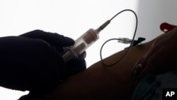  FILE - A patient has blood drawn for a liquid biopsy at a hospital in Philadelphia, April 28, 2015. 
