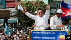 FILE - In this June 2, 2017, file photo, opposition party Cambodia National Rescue Party (CNRP) leader Kem Sokha greets his supporters at a rally in Phnom Penh. The European Union said Tuesday it has suspended assistance to Cambodia’s election commission following last month’s dissolution of the country’s main opposition party and warned that next July’s general election will not be legitimate if the opposition is not allowed to participate. (AP Photo/Heng Sinith, File)