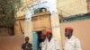 This photo taken on June 1, 2013 shows soldiers standing guard at the entrance of the main prison in Niamey. 