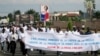Burundian journalists carry a banner as they march in the streets of Burundi's capital Bujumbura on May 03, 2011. 