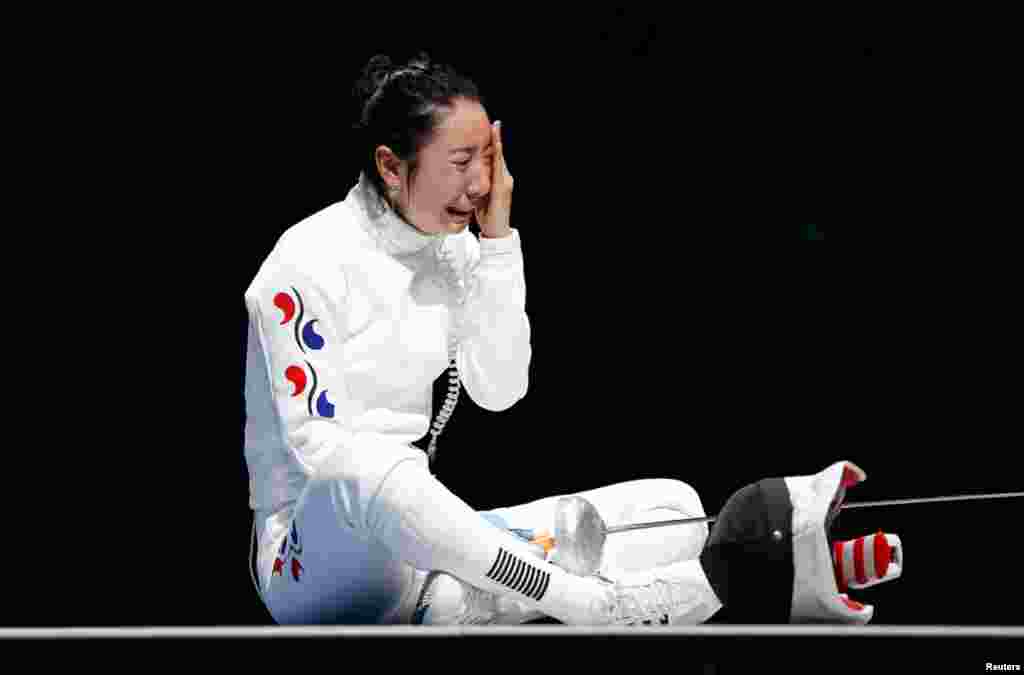 South Korea's Shin A Lam reacts after being defeated by Germany's Britta Heidemann during their women's epee individual semifinal fencing competition at the ExCel venue.