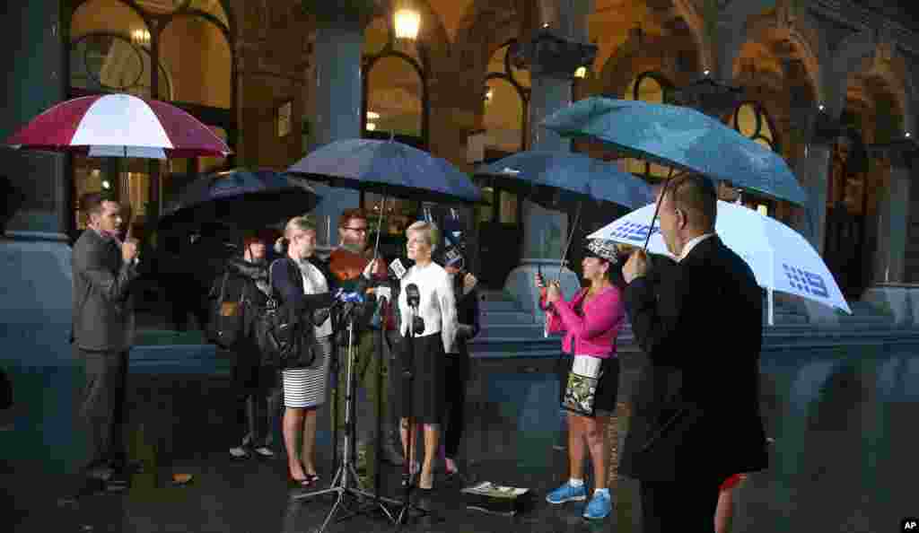 Julie Bishop, Australia's Minister for Foreign Affairs, stands in the rain as she comments on the release of journalist Peter Greste from an Egyptian jail, Sydney, Australia, Feb. 2, 2015.