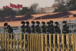Paramilitary officers wearing masks line up in front of the Tiananmen Gate, as the country is hit by an epidemic of the new coronavirus, in Beijing, China Jan. 30, 2020.