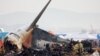 FILE - People work at the site where an aircraft went off the runway and crashed at Muan International Airport, in Muan, South Korea, Dec. 30, 2024.
