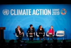 United Nations Secretary-General Antonio Guterres, far left, and young environmental activists look on as Greta Thunberg, of Sweden, far right, addresses the Climate Action Summit in the United Nations General Assembly, Sept. 23, 2019.