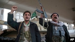 Houthi Shiite fighters chant slogans as they guard a street leading to the residence of former Yemeni President Ali Abdullah Saleh, in Sanaa, Yemen, Dec. 4, 2017. 