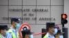 FILE - Policemen walk past the US consulate in Chengdu, southwestern China's Sichuan province, July 26, 2020. 