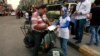 An Egyptian on his motorbike signs a petition for Tamarod, Arabic for "rebel", a campaign calling for the ouster of Egyptian President Mohammed Morsi and for early presidential elections in the Shubra neighborhood in Cairo, Egypt, June 2, 2013. 