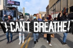 Protesters march through downtown Minneapolis a day before jury selection is scheduled to begin for the trial of Derek Chauvin, the former Minneapolis policeman accused of killing George Floyd, in Minneapolis, Minnesota, March 7, 2021.