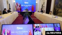 Vietnam's Deputy Prime Minister and Foreign Minister Pham Binh Minh chats in a video meeting with Chinese State Councillor Wang Yi and other leaders during the ASEAN-China ministerial meeting in Hanoi, Vietnam, Sept. 9, 2020. 
