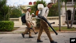 Government fumigators prepare to spray homes for mosquitoes in Havana, Cuba, Feb. 22, 2016.