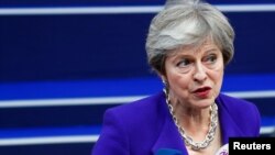 Britain's Prime Minister Theresa May speaks to the media as she arrives at the European Union leaders summit in Brussels, Belgium, Oct. 18, 2018.