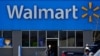FILE - A woman pushes a shopping cart to enter a Walmart in Rolling Meadows, Ill., Nov. 5, 2020.