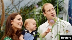 Britain's Catherine, Duchess of Cambridge, carries her son Prince George alongside her husband Prince William as they visit the Sensational Butterflies exhibition at the Natural History Museum in London, July 2, 2014.