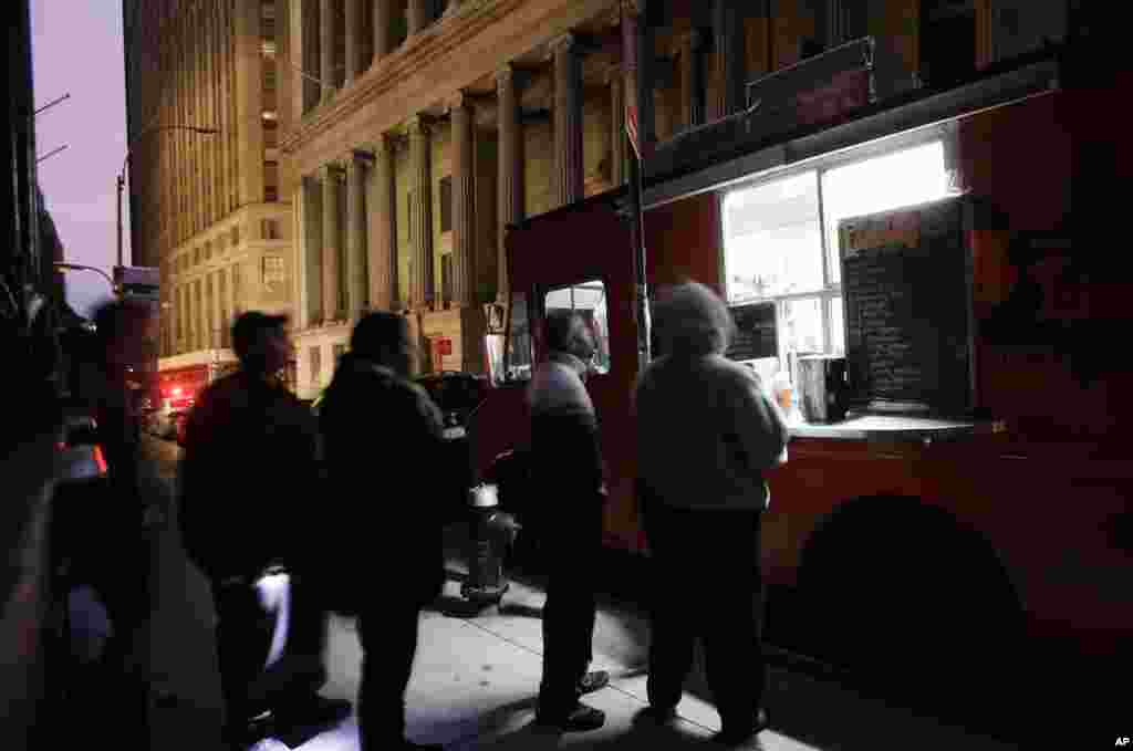 People line up at a coffee truck in New York's financial district, Oct. 31, 2012 ahead of the first opening for Wall Street this week following a two-day shutdown due to superstorm Sandy.