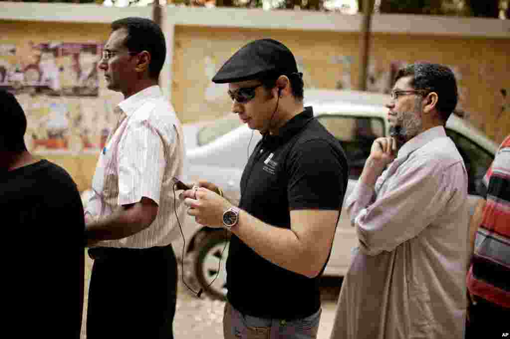 Ahmed Maher, a co-founder of the April 6 Revolutionary Movement, waits in line to vote at a polling center in a southern suburb of Cairo, Egypt, May 23, 2012.