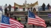Para pendukung Presiden AS Donald Trump membentangkan spanduk bertuliskan "Kami adalah Rakyat," bendera Three Percenters, dan bendera 13 bintang Betsy Ross, berkumpul di depan Gedung Kongres AS, di Washington, 6 Januari 2021. 