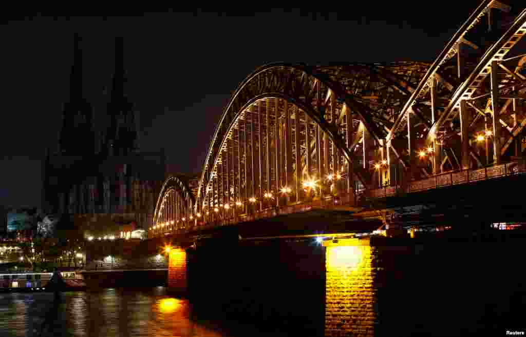 The UNESCO World Heritage Cologne Cathedral and the Hohenzollern railway bridge along the river Rhine are seen during Earth Hour in Cologne, Germany, March 30, 2019.