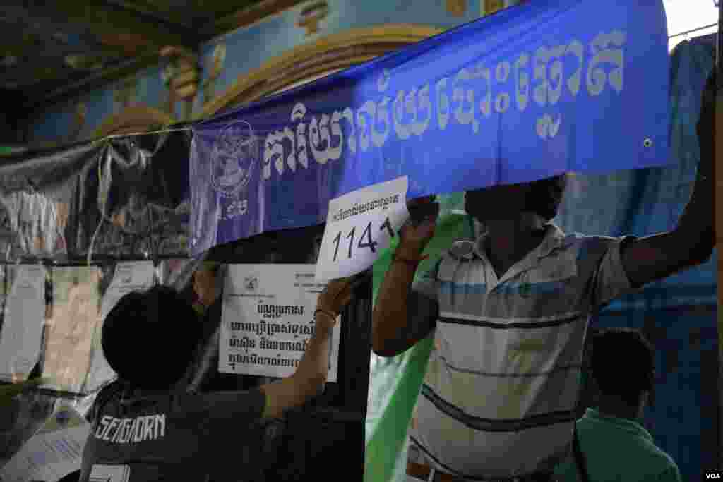 ក្រុមមន្ត្រីរៀបចំការបោះឆ្នោត កំពុងរៀបចំការិយាល័យបោះឆ្នោត និងបិទបញ្ជីបោះឆ្នោតថ្មី នៅតាមការិយាល័យបោះឆ្នោតមួយ ត្រៀមសម្រាប់ថ្ងៃបោះឆ្នោត ក្នុងរាជធានីភ្នំពេញ នៅថ្ងៃទី៣ ខែមិថុនា ឆ្នាំ២០១៧។ (ហ៊ាន សុជាតា/VOA)
