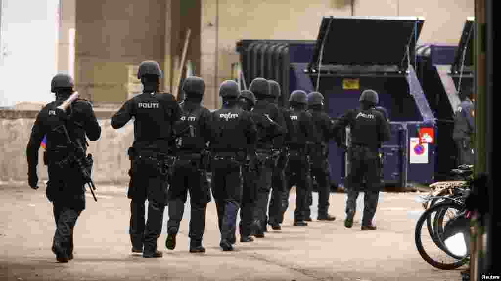 Police work in a cordoned off area in a street near Norrebro Station following shootings in Copenhagen, Feb. 15, 2015.