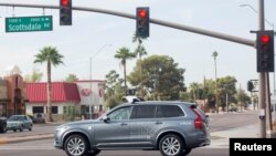 FILE -A self-driving Volvo vehicle, purchased by Uber, moves through an intersection in Scottsdale, Arizona, Dec. 1, 2017. 