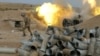An ethnic Armenian soldier fires an artillery piece during a military conflict over the breakaway region of Nagorno-Karabakh, in this handout picture released Oct. 5, 2020.