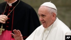 FILE - Pope Francis greets faithful during his weekly general audience, in the Pope Paul VI hall, at the Vatican, Jan. 18, 2017.