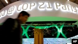 A man walks past the Indian Pavilion at the COP21, the United Nations Climate Change Conference Monday, Dec. 7, 2015 in Le Bourget, north of Paris. (AP Photo/Christophe Ena)