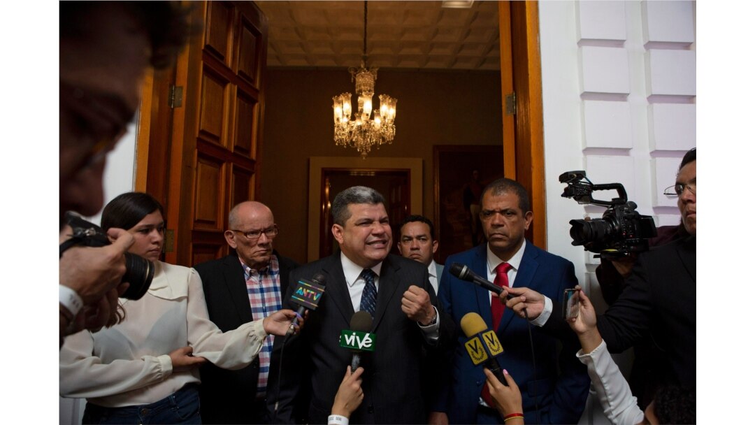 Lawmaker Luis Parra speaks to the press after many opposition lawmakers were blocked by police from entering the day's National Assembly session to elect a new leadership, in Caracas, Venezuela, Jan. 5, 2020.