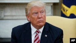 President Donald Trump talks to reporters during a meeting with Dr. Henry Kissinger, former Secretary of State and National Security Advisor under President Richard Nixon, in the Oval Office of the White House, May 10, 2017, in Washington.