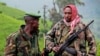 A picture taken on June 3, 2012 shows rebels of the mutinous armed force known as M23 patrolling on the hill of Kavumu in North Kivu, Democratic Republic of the Congo (DRC).