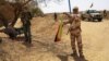 A fighter with the Tuareg separatist group MNLA (National Movement for the Liberation of Azawad) brandishes a separatist flag for the region they call Azawad outside the local regional assembly, where MNLA members met with the Malian army, the U.N. missio