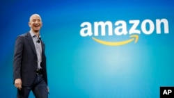 FILE - Amazon CEO Jeff Bezos walks onstage for the launch of the new Amazon Fire Phone, in Seattle. 