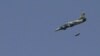 A Syrian Air Force fighter jet launches missiles at El Edaa district in Syria's northwestern city of Aleppo, September 1, 2012.