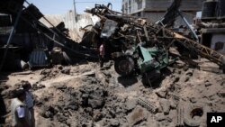 A Palestinian man inspects a damaged artesian well drilling truck after an early morning Israeli airstrike hit a workshop in Gaza City, Saturday, July 2, 2016. 