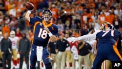 FILE - Denver Broncos quarterback Peyton Manning throws a touchdown pass during a NFL football game against the San Francisco 49ers.