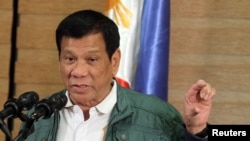 FILE - Philippine President Rodrigo Duterte speaks during a news conference in Davao, Sept. 18, 2016.
