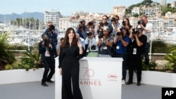 Ceremony host Monica Bellucci poses for photographers during the photo call for the film Ismael's Ghosts, at the 70th international film festival, Cannes, southern France, May 16, 2017.