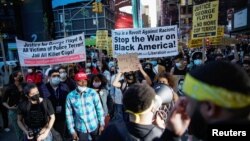 People gather with signs after the verdict in the trial of former Minneapolis police officer Derek Chauvin, found guilty of the death of George Floyd, in New York City, New York, U.S., April 20, 2021. (REUTERS/Eduardo Munoz)