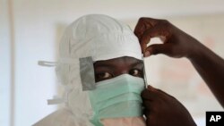 FILE - A nurse gears up to enter a high-risk zone of an Ebola treatment unit run by Doctors Without Borders (Medecins Sans Frontieres) in Monrovia, Liberia.