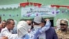 Ethiopia's Prime Minister Abiy Ahmed is hugged by a supporter after casting his vote in the general election, in his home town of Beshasha, in the Oromia region of Ethiopia, June 21, 2021.