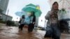 Women wade through a flooded street in Jakarta, Indonesia, January 17, 2013.