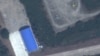 This handout satellite image taken on Nov. 22, 2021, by Planet Labs PBC shows what Dutch peace organization PAX says are two Chinese-origin Wing Loong drones parked at Hara Meda airbase in Bishoftu, Ethiopia. (Planet Labs PBC/AFP)