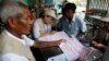 Myanmar census enumerators ask questions to a family member while collecting information in Sittwe, Rakhine State, western Myanmar, Monday, March 31, 2014. Enumerators fanned out across Myanmar on Sunday for a census that has been widely criticized for st