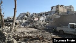 The aftermath of an explosion in Al-Salam Square in Kobani carried out by ISIS using a truck rigged with explosives, Oct. 22, 2014. 