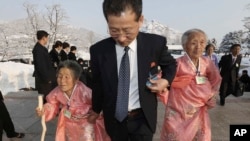 A North Korean man escorts his relatives as they reunite with their South Korean family members during the Separated Family Reunion Meeting at Diamond Mountain resort in North Korea, Feb. 21, 2014.