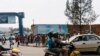 FILE - A passenger rides on a fuel-powered moto-taxi in Kigali, Rwanda, July 30, 2017. Rwanda is introducing electric motorcycles, with more than 600 being built for use in the country.